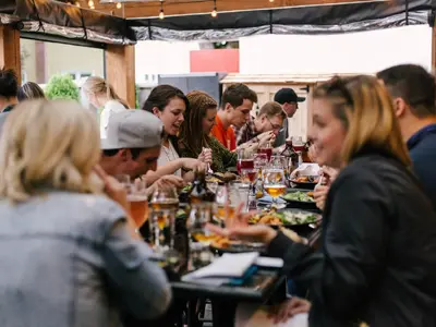 A group of way too beautiful people in a restaurant.