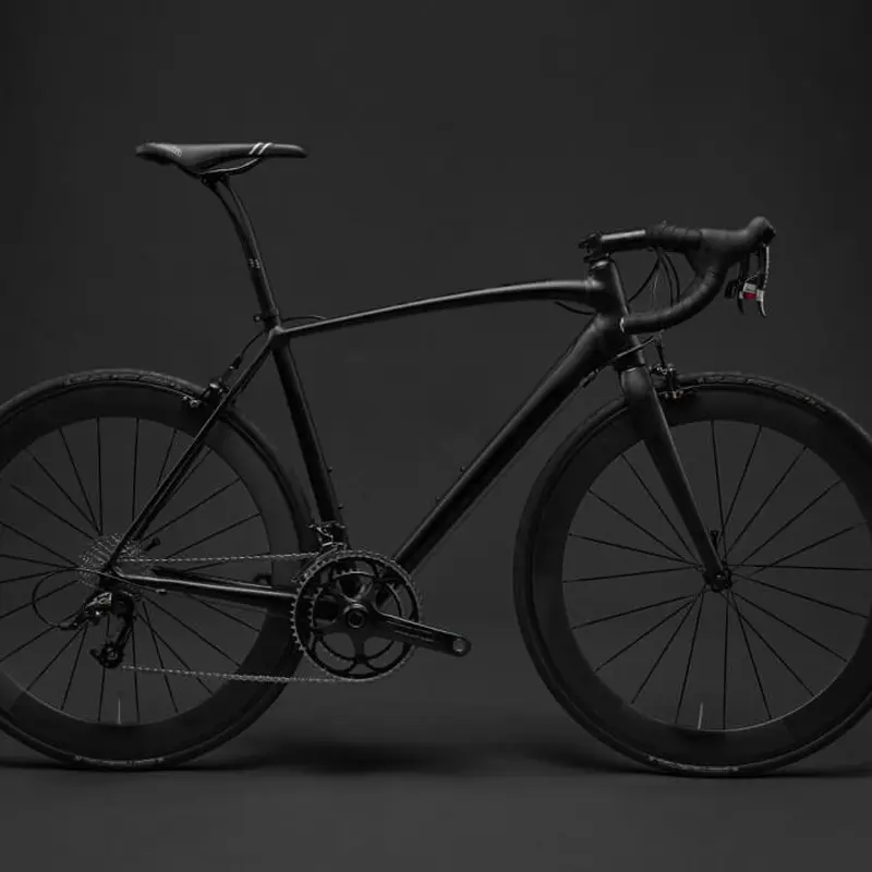 Black bike in front of a black background. Yay for contrast!